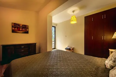a bedroom with a large bed and a dresser at Villa Milana Budva in Budva
