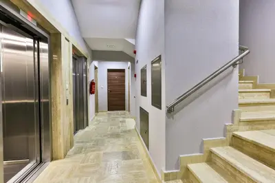 a hallway with stairs in a building at Gufo Apart in Budva