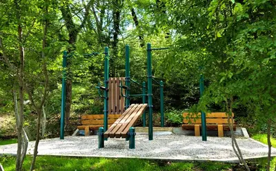 a playground with two benches in a park at Oak Leaf Residences in Budva