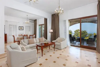 a living room with white furniture and a table at Oak Leaf Residences in Budva