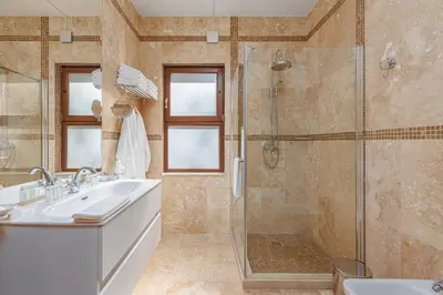 a bathroom with a sink and a shower at Oak Leaf Residences in Budva