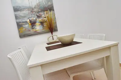 a white dining room table with a bowl on it at Muo Apartments in Kotor
