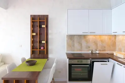 a kitchen with a table and a dining room at Harmonia Panorama Apartments in Budva