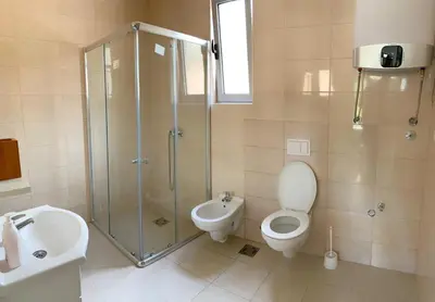 a bathroom with a shower and a toilet and a sink at Apartment kalina in Bar