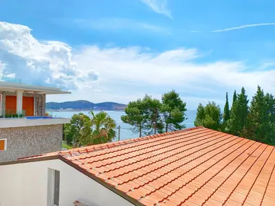 an orange tile roof of a house with a view of the water at Apartment kalina in Bar