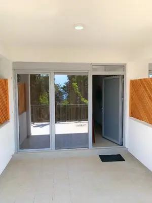an empty living room with sliding glass doors at Apartment kalina in Bar
