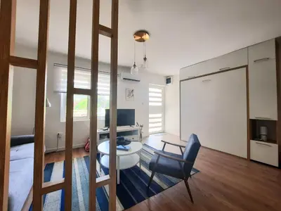 a room with a desk and a chair in a room at Montenegro Sea Pearl Apartments Petrovac in Petrovac na Moru