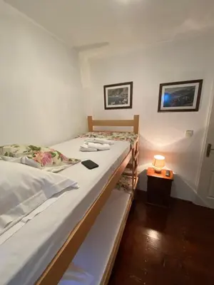 a bedroom with two twin beds and a lamp at Viktor Rooms in Kotor