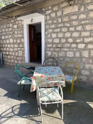 a table and two chairs sitting outside of a building at Viktor Rooms in Kotor