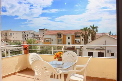 a balcony with a table and chairs on a balcony at Nir Apartments Budva in Budva