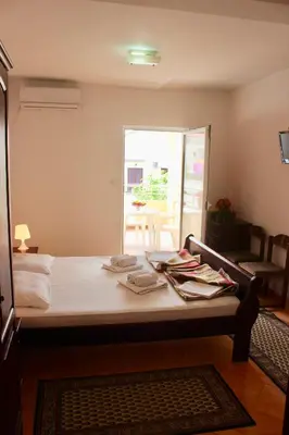 a bedroom with a bed and a table with towels on it at Nir Apartments Budva in Budva