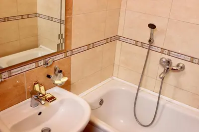 a bathroom with a shower and a sink and a tub at Nir Apartments Budva in Budva