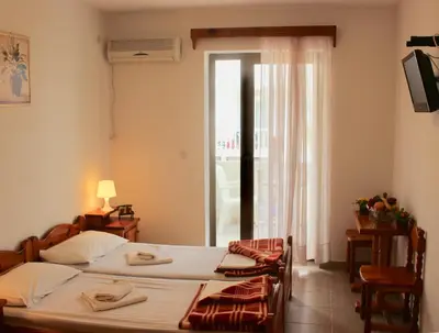 a bedroom with two beds and a window with a view at Nir Apartments Budva in Budva