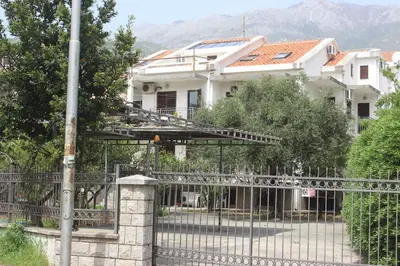 a house with a gate and a fence at Nir Apartments Budva in Budva