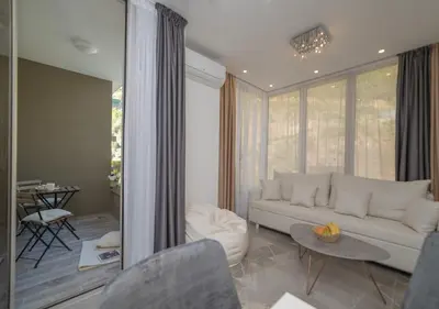 a living room with a white couch and a table at Twins in Rafailovici