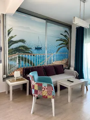 a living room with a couch and a view of the ocean at Premium Lea Apartments in Ulcinj