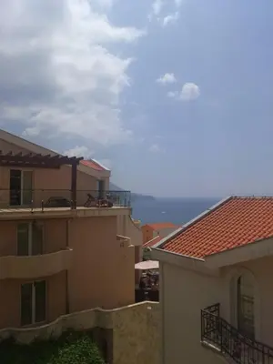 a view of the ocean from between two buildings at Luxury Villas Marko in Tivat