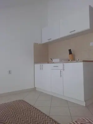a kitchen with white cabinets and a sink at Luxury Villas Marko in Tivat