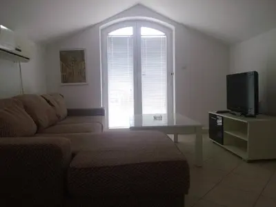 a living room with a couch and a tv at Luxury Villas Marko in Tivat