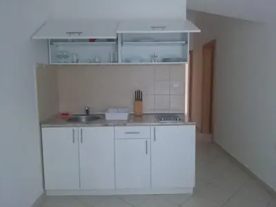 a kitchen with white cabinets and a sink at Luxury Villas Marko in Tivat