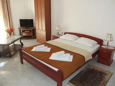 a bedroom with a bed with two towels on it at Apartments Kalluka in Sveti Stefan