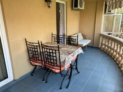 a room with a table and chairs on a balcony at Apartments Kalluka in Sveti Stefan