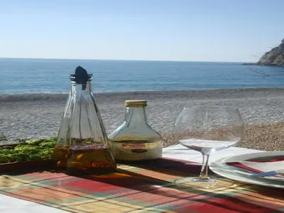a table with two bottles of wine and a glass at Apartments Galija in Petrovac na Moru