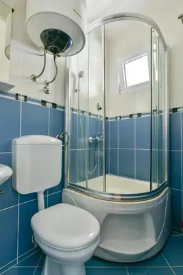a bathroom with a toilet and a shower at Apartments Srzentic in Petrovac na Moru