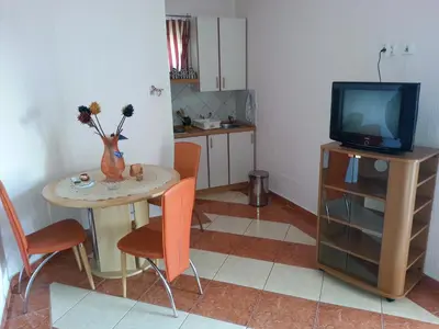 a living room with a small table and a television at Apartments Stevo Nikočević in Bar