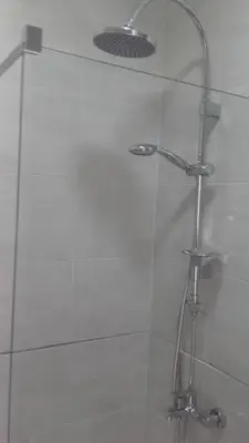 a shower with a glass door in a bathroom at Apartments Stevo Nikočević in Bar