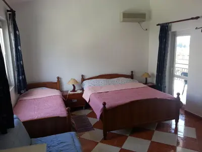 a bedroom with two beds and a window at Apartments Stevo Nikočević in Bar