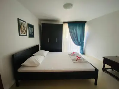 a bedroom with a large bed with a window at Lake View Apartment Dodosi in Dodoši