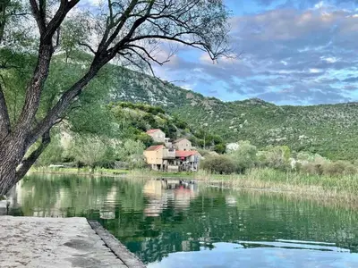a house on the side of a river at Lake View Apartment Dodosi in Dodoši