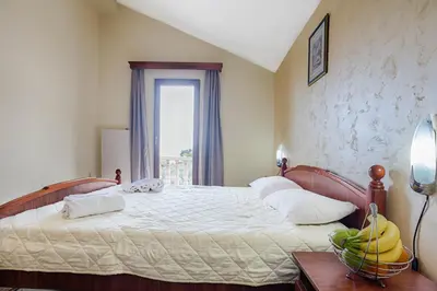 a bedroom with a bed with bananas on it at Mali Miločer Bay Accommodation in Sveti Stefan