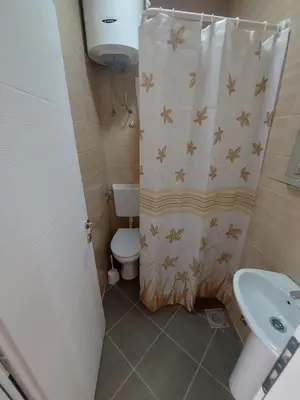 a bathroom with a toilet and a shower curtain at Apartmani Sunce in Bar