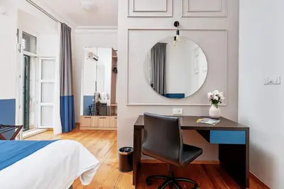 a bedroom with a desk and a bed and a mirror at Kotor Nest in Kotor