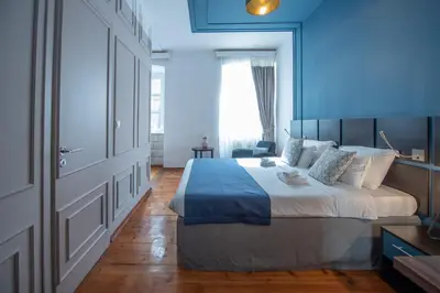 a bedroom with a large bed with a blue wall at Kotor Nest in Kotor