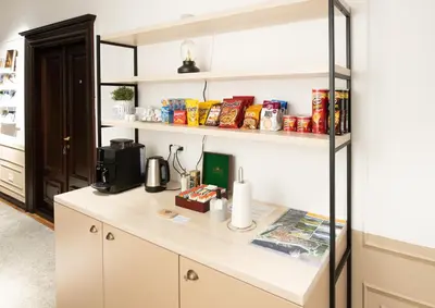 a kitchen with a counter and shelves with food at Kotor Nest in Kotor