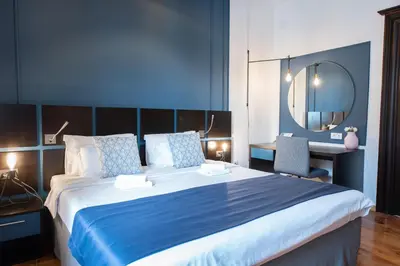 a bedroom with a large bed and a mirror at Kotor Nest in Kotor