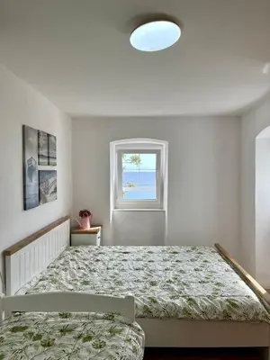 a bedroom with a bed and a window at Milena in Petrovac na Moru
