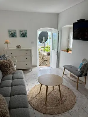 a living room with a couch and a table at Milena in Petrovac na Moru