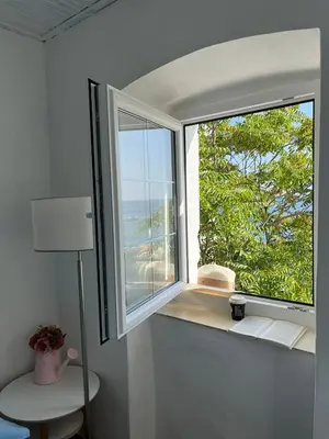 a window in a room with a view of the ocean at Milena in Petrovac na Moru
