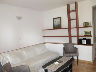a living room with a couch and a table at Apartments Villa Pržno in Sveti Stefan