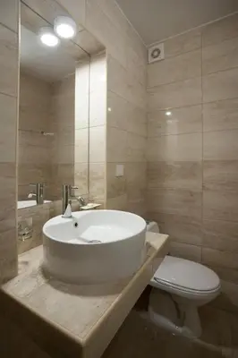 a bathroom with a white sink and a toilet at Apartments Grand in Sveti Stefan