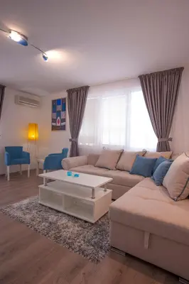 a living room with a couch and a coffee table at Apartments Grand in Sveti Stefan