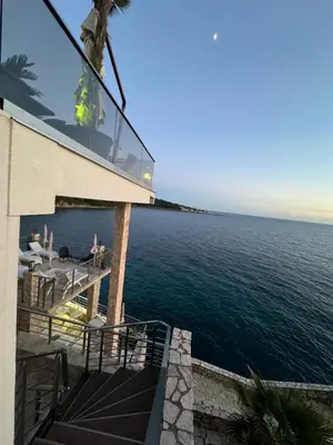a view of the ocean from the balcony of a house at Apart Lux Beciragic in Dobra Voda