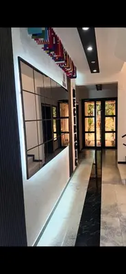 a hallway of a building with a wall of windows at Apart Lux Beciragic in Dobra Voda