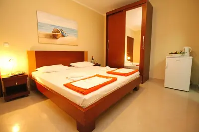 a bedroom with a bed with two towels on it at Guest House Villa Pastrovka in Sveti Stefan