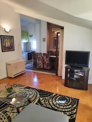 a living room with a flat screen tv on a table at Apartmani Asanović in Budva