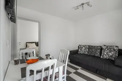 a living room with a couch and a table and chairs at Apartments Natali in Bar
